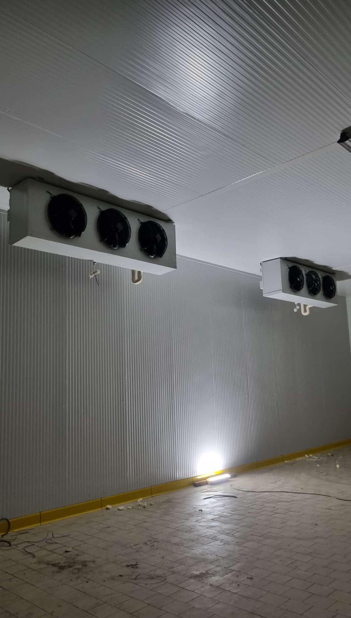 Two ceiling-mounted refrigeration evaporators inside a cold-storage room.